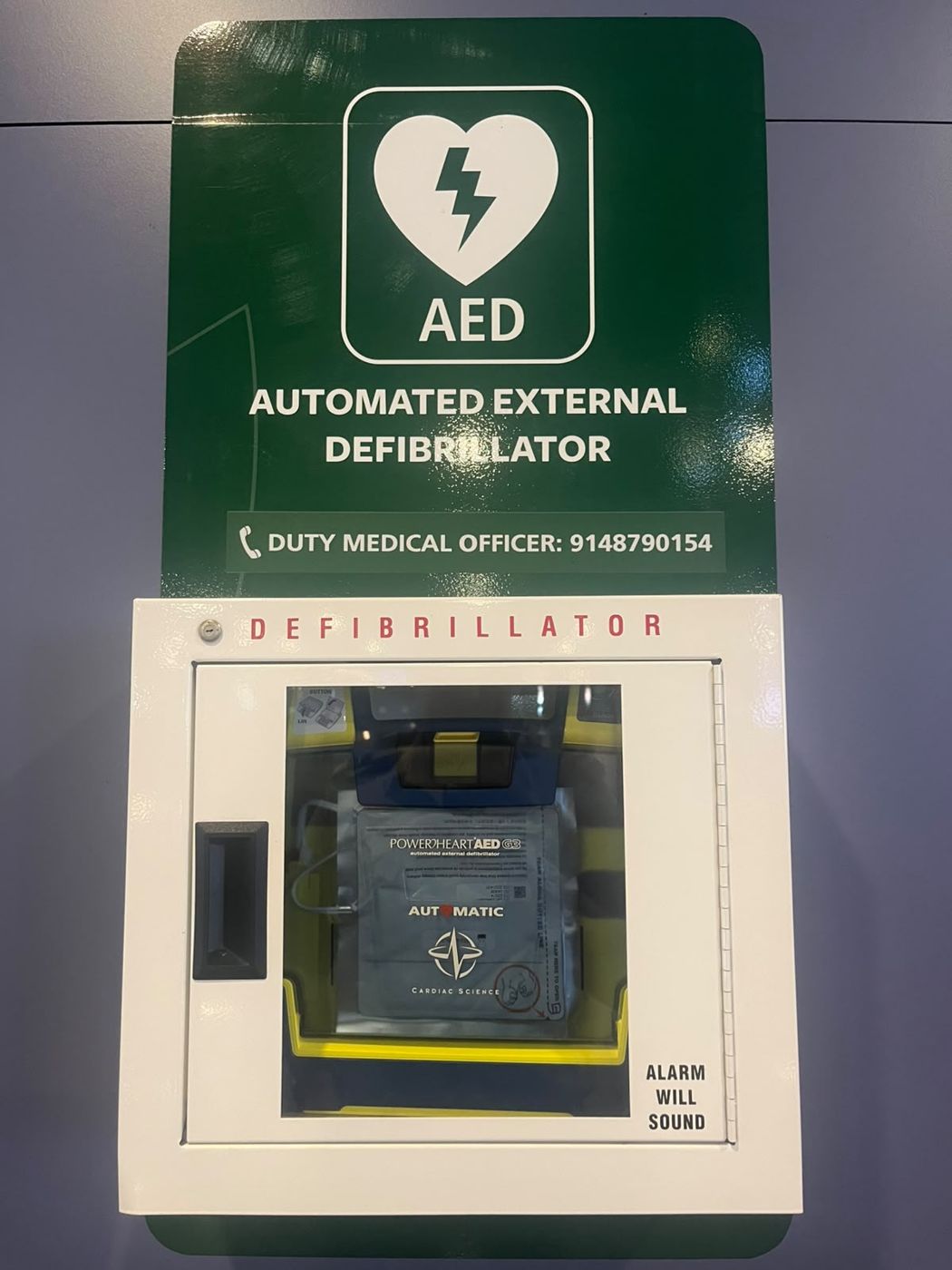A wall-mounted AED defibrillator cabinet