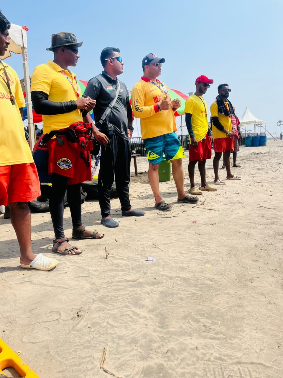Beach lifeguards on patrol with rescue equipment