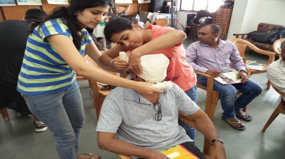 Trainees practising a head bandage