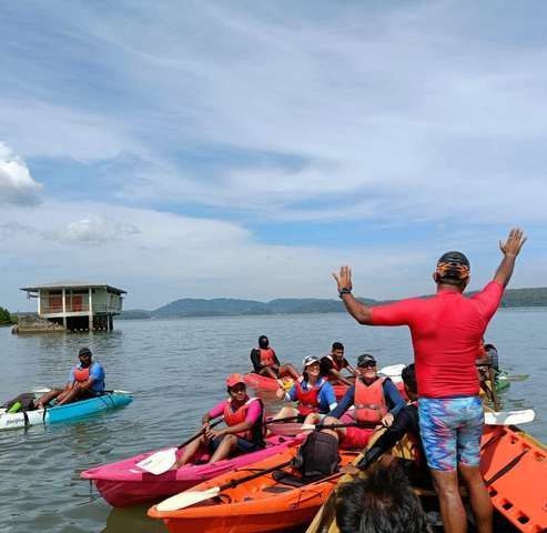 An instructor briefing kayakers on open water safety