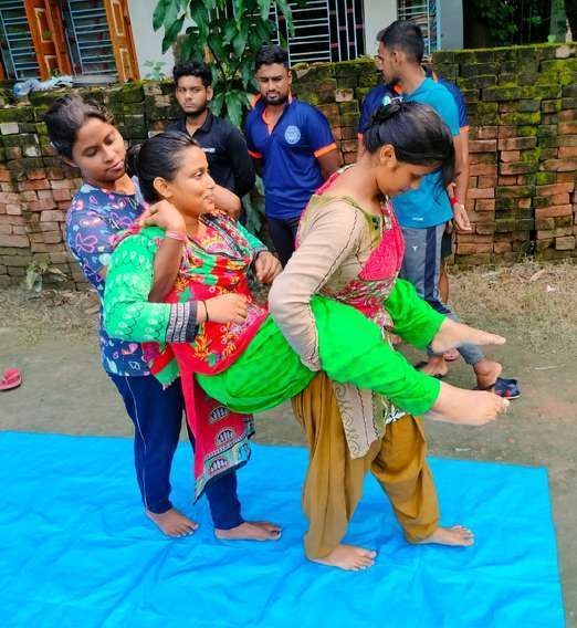 Women practising a two-person casualty carry